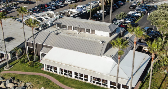 Standing seam metal roof installed by Diamond Roofing on an oceanfront commercial building in San Diego