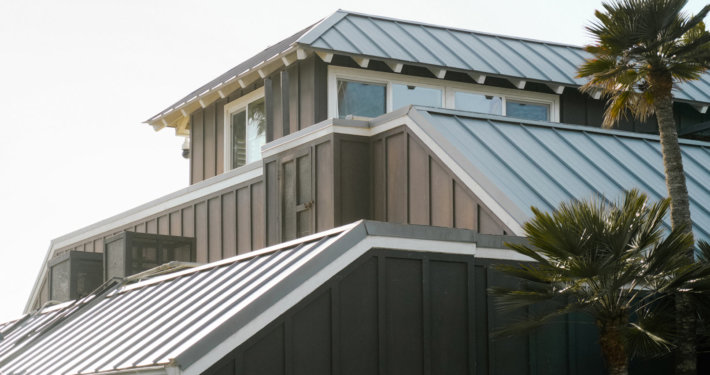 Close-up of a standing seam metal roof installed by Diamond Roofing on a San Diego coastal building